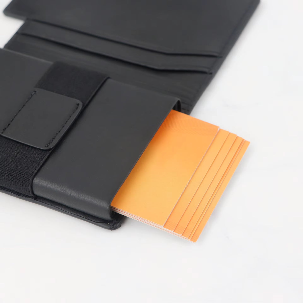 Riva Folio Wallet cards fanned out of the pop-up case