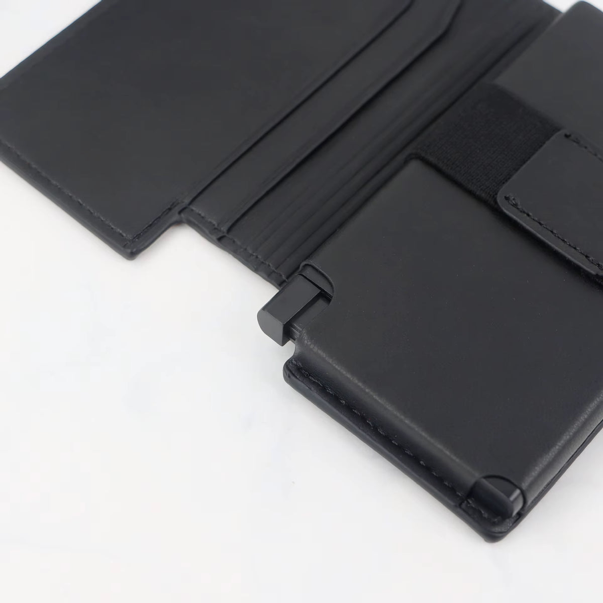 Close-up of the Riva Folio Wallet push lever and stitching